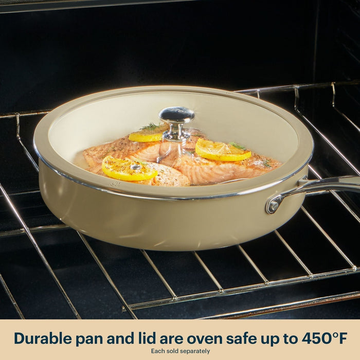 Beige ceramic cookware set with salmon dish inside an oven