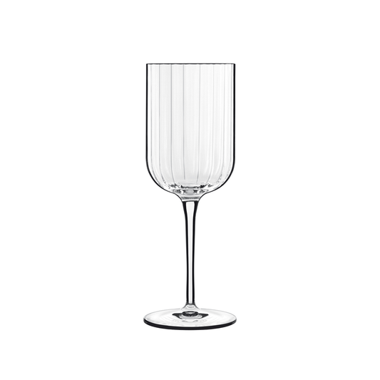 A clear Bach White Wine glass by Luigi Bormioli on a white background