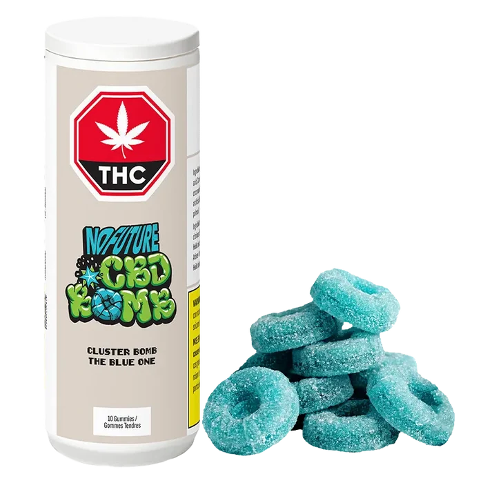 White cylindrical container labeled "CBD Cluster Bomb - The Blue One Gummies" stands to the left of a small pile of sugar-coated blue ring gummies.