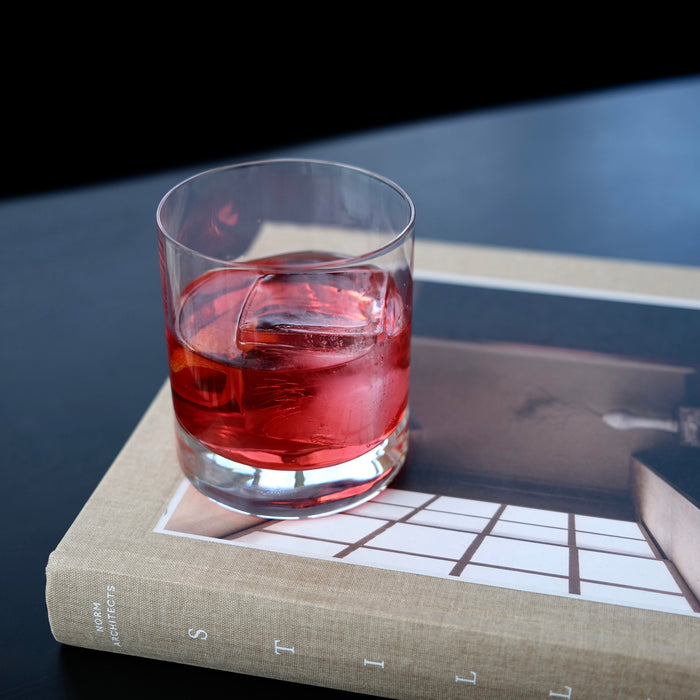 Glass with non-alcoholic cocktail  on a book with a dark background