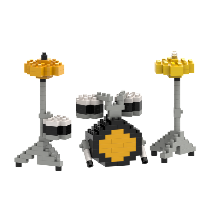 The Brixies Large Zip Bag Drum Kit features a miniature drum set built from gray, black, white, and yellow bricks—including a bass drum with a yellow center, two toms, two cymbals on stands, and drumsticks—all packed in a handy zip bag.