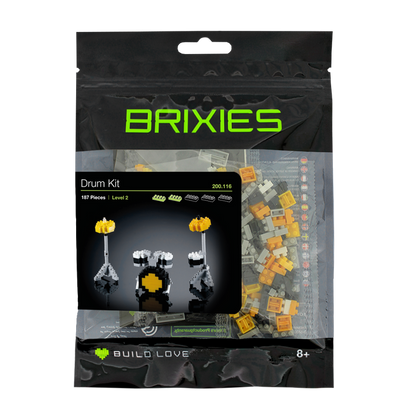 The Brixies Large Zip Bag Drum Kit includes 187 micro-bricks for ages 8+, featuring yellow and gray pieces and an image of the finished miniature drum set on the front.