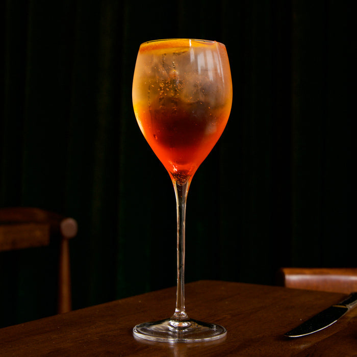 Spritz cocktail in a Magnifico Small wine glass on a dark background