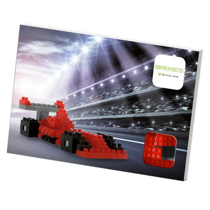 A Brixies Postcard Racing Car box showcases a red race car built from micro bricks on a racetrack with bright lights, and the Brixies logo appears in the top right corner.