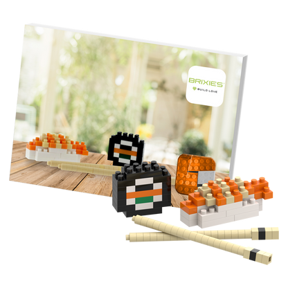 The Brixies Postcard Sushi is a small, colorful 3D sushi model built from blocks, displayed with chopsticks and a Brixies logo card—perfect as a mini build kit or unique mailable postcard gift.