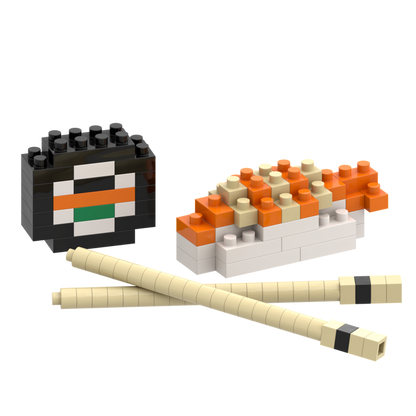 Brixies Postcard Sushi features toy building blocks arranged as a 3D sushi roll, nigiri with orange topping, and chopsticks on a white background—ideal as a mini build kit or unique mailable postcard gift.