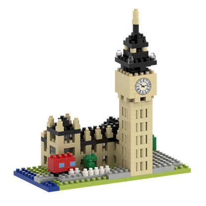 The Brixies Small Gift Box Big Ben is a micro-brick model of London’s landmark, featuring a clock face, red double-decker bus, and green tree on a grey-green base beside the Houses of Parliament.