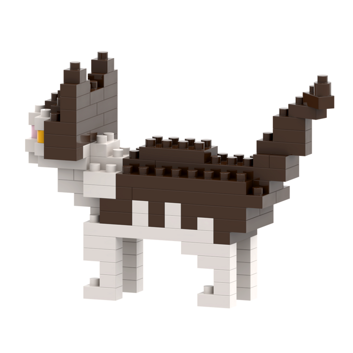 The Brixies Small Zip Bag Cat is a micro-brick construction kit featuring a blocky 3D cat in brown, white, and black with upright ears and raised tail, standing on four legs against a plain white background.