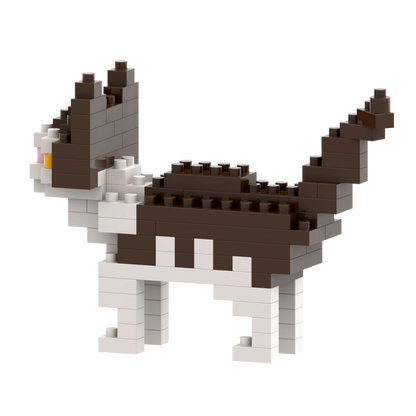 The Brixies Small Zip Bag Cat is a micro-brick construction kit featuring a blocky 3D cat in brown, white, and black with upright ears and raised tail, standing on four legs against a plain white background.