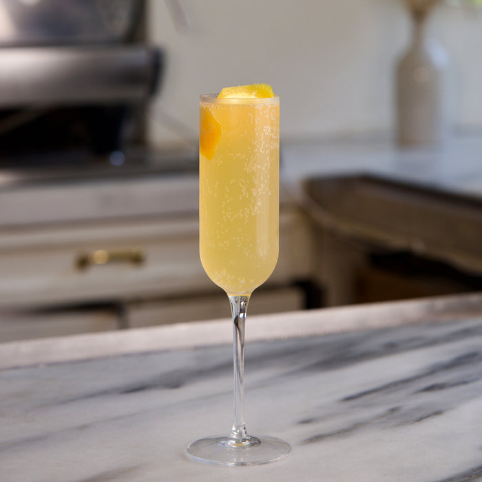Cocktail in a tall glass with a blurred kitchen background