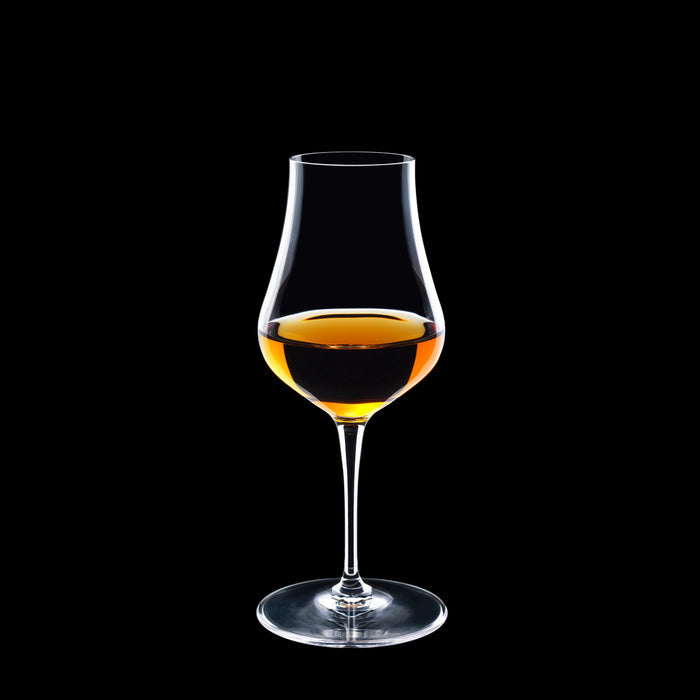 Vinoteque Snifter glass filled with a spirit on a black background